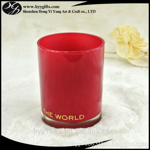 empty red glass votive candle holder with gold aluminum foil logo